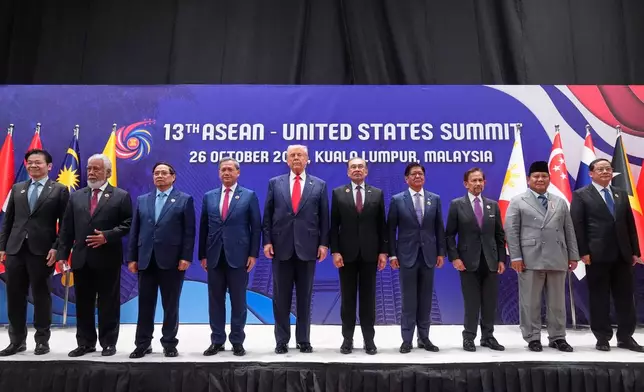 President Donald Trump poses for a family photo with, from left, Singapore Prime Minister Lawrence Wong, East Timor's Prime Minister Kay Rala Xanana Gusmao, Vietnam's Prime Minister Pham Minh Chinh, Cambodian Prime Minister Hun Manet, Malaysian Prime Minister Anwar Ibrahim, Philippine President Ferdinand Marcos Jr., the Sultan of Brunei Hassanal Bolkiah, Indonesian President Prabowo Subianto and Laos' Prime Minister Sonexay Siphandone at the ASEAN Summit in Kuala Lumpur, Malaysia, Sunday, Oct. 26, 2025. (AP Photo/Mark Schiefelbein)