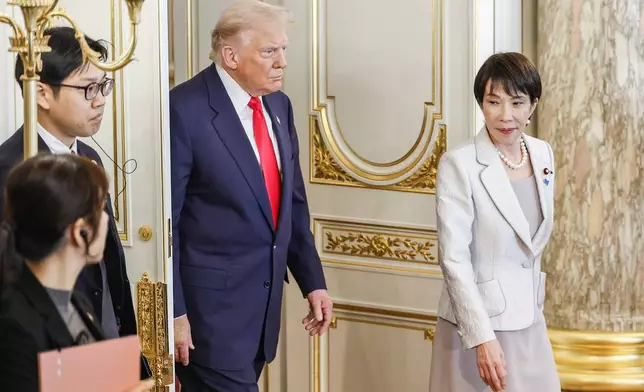 U.S. President Donald Trump, center, and Japan's Prime Minister Sanae Takaichi, right, arrive for the Japan-US summit meeting at Akasaka Palace State Guest House in Tokyo, Japan, Tuesday, Oct. 28, 2025. (Franck Robichon/Pool Photo via AP)
