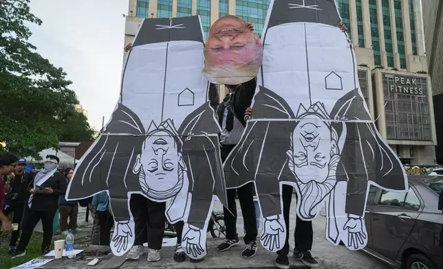 Protesters hold a cut out of President Donald Trump and Israel Prime Minister Benjamin Netanyahu, during a demonstration against U.S. President Donald Trump's attendance at the Association of Southeast Asian Nations (ASEAN) Summit, in Kuala Lumpur, Malaysia, on Sunday, Oct. 26, 2025. (AP Photo/Azneal Ishak)