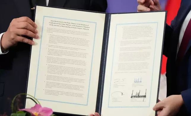 The document signed by Cambodian Prime Minister Hun Manet and Thailand's Prime Minister Anutin Charnvirakul, left, on the sidelines of the ASEAN Summit in Kuala Lumpur, Malaysia, Sunday, Oct. 26, 2025. (AP Photo/Mark Schiefelbein)