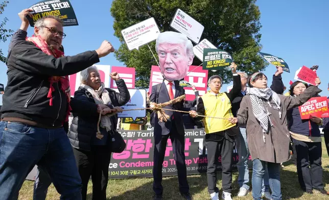 A protester wearing a mask of U.S. President Donald Trump and others shout slogans during a press conference denouncing Trump's planned visit in Gyeongju, South Korea, Wednesday, Oct. 29, 2025. (AP Photo/Lee Jin-man)