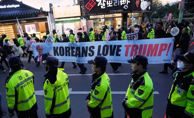 Supporters of U.S. President Donald Trump march during a rally to welcome his visit in Gyeongju, South Korea, Wednesday, Oct. 29, 2025. (AP Photo/Ahn Young-joon)