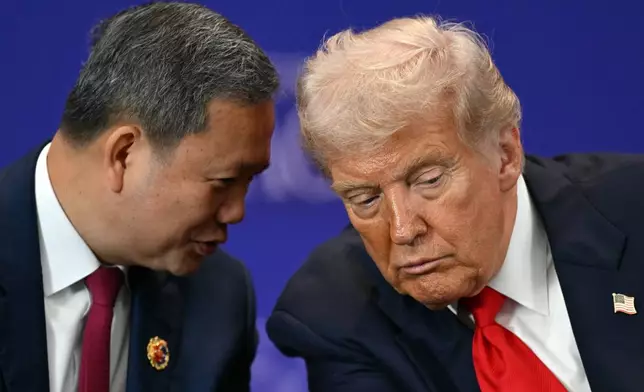 U.S. President Donald Trump listens to Cambodia's Prime Minister Hun Manet ahead of the ceremonial signing of a ceasefire agreement between Thailand and Cambodia on the sidelines of the 47th Association of Southeast Asian Nations (ASEAN) summit in Kuala Lumpur, Malaysia, Sunday, Oct. 26, 2025. (Mohd Rasfan/Pool Photo via AP)