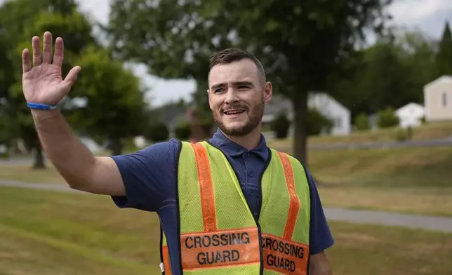 Crossing guard Travis Callis works outside Martinsburg North Middle School in Martinsburg, W.Va., on Sept. 5, 2025. (AP Photo/River Zhang)