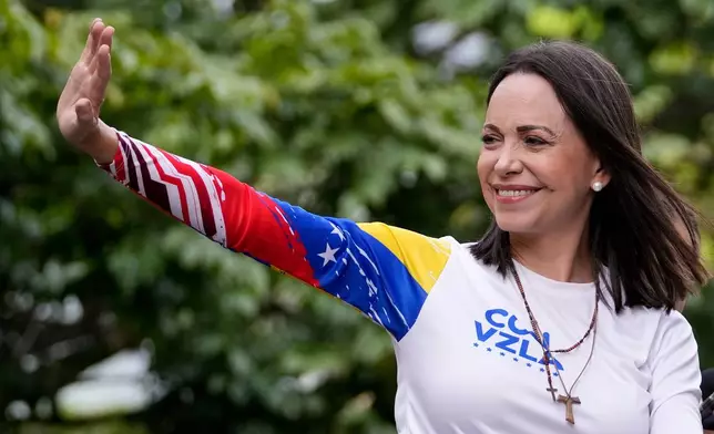 FILE - Opposition leader Maria Corina Machado waves from atop a truck during the closing election campaign rally for presidential candidate Edmundo Gonzalez in Caracas, Venezuela, Thursday, July 25, 2024. (AP Photo/Matias Delacroix, File)