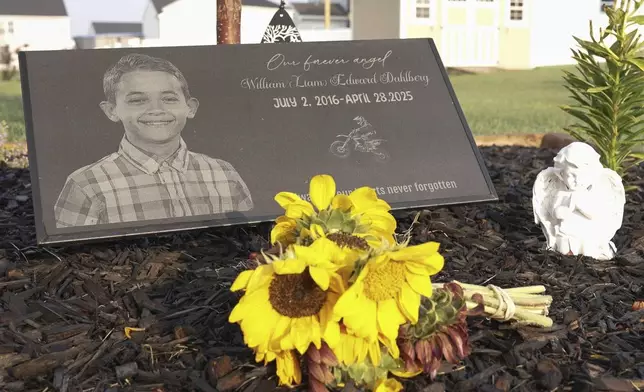 Liam Dahlberg's memorial sits in his family's front yard in Lowell, Ind., on Wednesday, Aug. 13, 2025. (AP Photo/Laura Bargfeld)