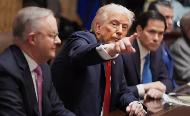 President Donald Trump, center, speaks during a meeting with Australian Prime Minister Anthony Albanese, left, as Secretary of State Marco Rubio listens in the Cabinet Room of the White House, Friday, October 20, 2025, in Washington. (AP Photo/Evan Vucci)