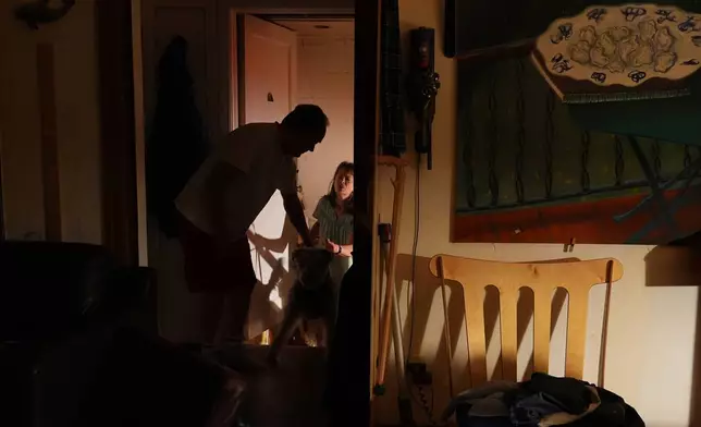 Ross Colquhoun wakes up his wife Mary E. Brunkow to talk about her winning a Nobel Prize in medicine for part of her work on peripheral immune tolerance, in Seattle, Monday, Oct. 6, 2025. (AP Photo/Lindsey Wasson)