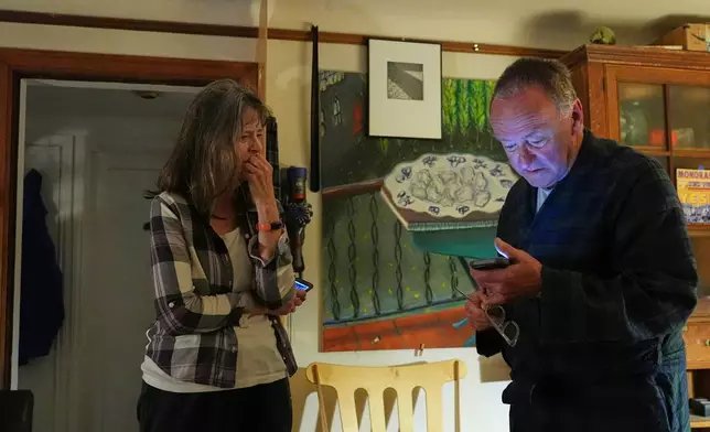 Mary E. Brunkow becomes emotional as her husband Ross Colquhoun speaks with her about her winning the Nobel Prize in medicine for part of her work on peripheral immune tolerance, in Seattle, Monday, Oct. 6, 2025. (AP Photo/Lindsey Wasson)