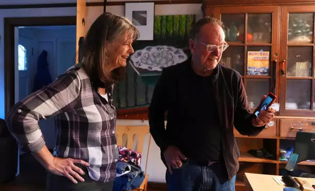 Mary E. Brunkow and her husband Ross Colquhoun talk with one of their daughters on the phone about her winning a Nobel Prize in medicine for part of her work on peripheral immune tolerance, in Seattle, Monday, Oct. 6, 2025. (AP Photo/Lindsey Wasson)