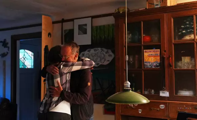 Mary E. Brunkow and her husband Ross Colquhoun embrace while celebrating her winning a Nobel Prize in medicine for part of her work on peripheral immune tolerance, in Seattle, Monday, Oct. 6, 2025. (AP Photo/Lindsey Wasson)