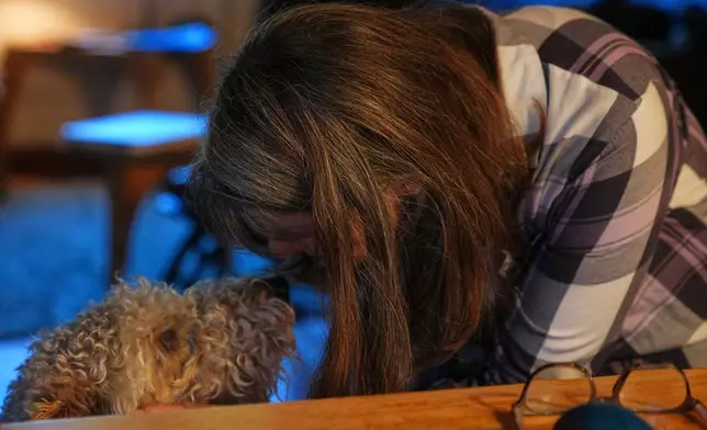 Mary E. Brunkow pets her dog Zelda after winning a Nobel Prize in medicine for part of her work on peripheral immune tolerance, in Seattle, Monday, Oct. 6, 2025. (AP Photo/Lindsey Wasson)