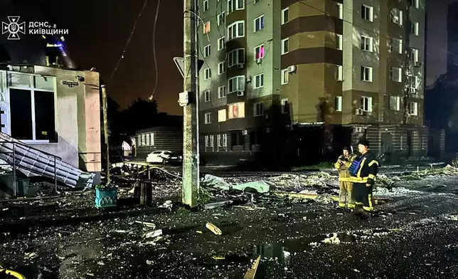 In this photo provided by the Ukrainian Emergency Service, emergency services personnel work the scene following a Russian attack in Brovary, near Kyiv, Ukraine, Friday, Oct. 10, 2025. (Ukrainian Emergency Service via AP)