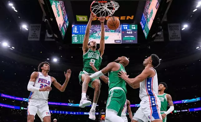 Boston Celtics forward Josh Minott (8) slams a dunk against the Philadelphia 76ers during the first half of an NBA basketball game, Wednesday, Oct. 22, 2025, in Boston. (AP Photo/Charles Krupa)