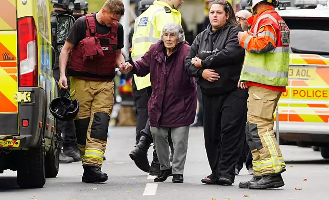 A member of the public is helped from the scene of a stabbing incident at Heaton Park Hebrew Congregation synagogue, in Crumpsall, Manchester, England, Thursday Oct. 2, 2025. (Peter Byrne/PA via AP)