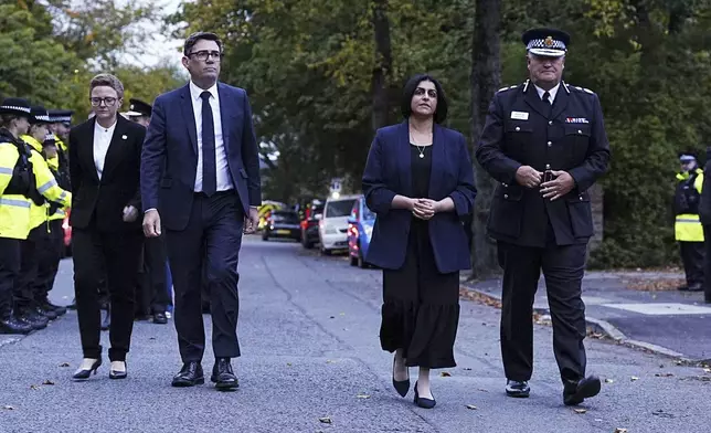 Britain's Home Secretary Shabana Mahmood, second right, Mayor of Greater Manchester Andy Burnham, secone left, and Chief Constable Sir Stephen Watson visit the scene following the incident at Heaton Park Hebrew Congregation synagogue in Crumpsall, Manchester, Thursday, Oct. 2, 2025. (Peter Byrne/PA via AP)