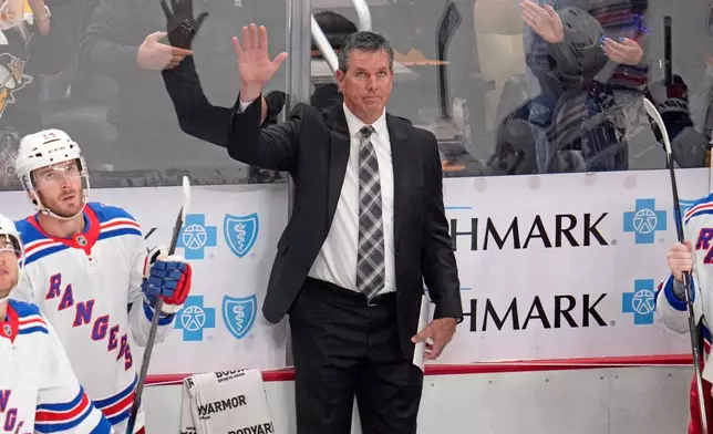 New York Rangers head coach Mike Sullivan acknowledges fans after a scoreboard tribute to his years a head coach of the Pittsburgh Penguins, during the first period of an NHL hockey game against the Pittsburgh Penguins in Pittsburgh, Saturday, Oct. 11, 2025. (AP Photo/Gene J. Puskar)