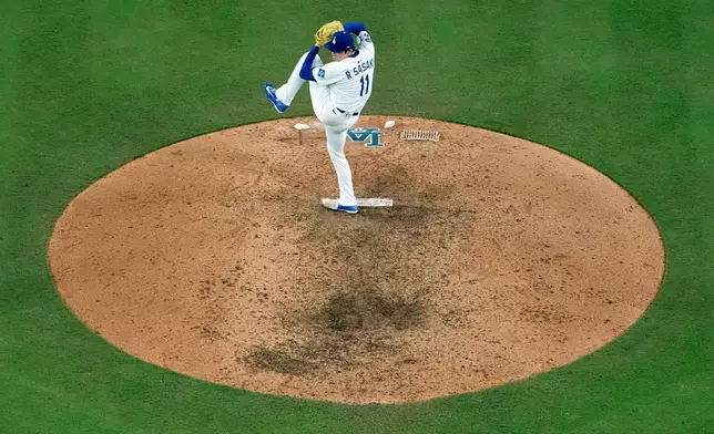 Los Angeles Dodgers pitcher Roki Sasaki throws against the Milwaukee Brewers during the ninth inning in Game 4 of baseball's National League Championship Series, Friday, Oct. 17, 2025, in Los Angeles. (AP Photo/Brynn Anderson)