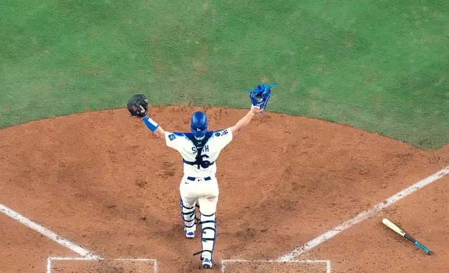 Milwaukee Brewers center fielder Blake Perkins celebrates their win against the Milwaukee Brewers in Game 4 of baseball's National League Championship Series, Friday, Oct. 17, 2025, in Los Angeles. (AP Photo/Brynn Anderson)