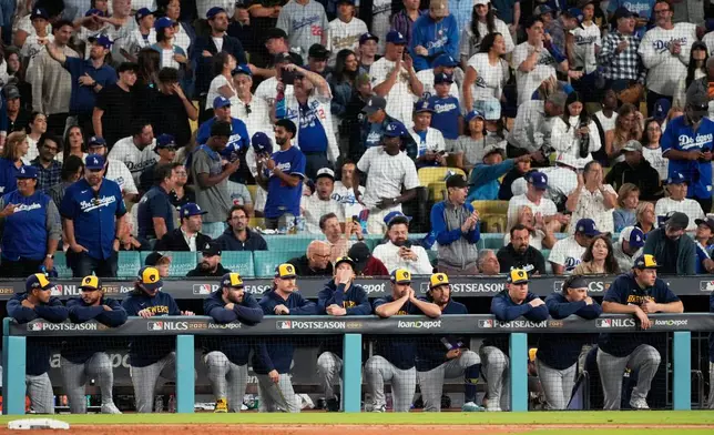 Members of the Milwaukee Brewers watch during the eighth inning in Game 4 of baseball's National League Championship Series against the Los Angeles Dodgers, Friday, Oct. 17, 2025, in Los Angeles. (AP Photo/Mark J. Terrill)