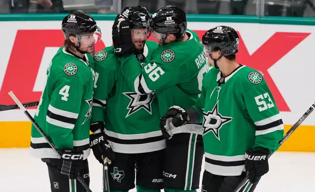 Dallas Stars' Miro Heiskanen (4), Tyler Seguin, second from left, Mikko Rantanen (96) and Wyatt Johnston (53) celebrate a goal scored by Seguin in the second period of an NHL hockey game against the Washington Capitals Tuesday, Oct. 28, 2025, in Dallas. (AP Photo/Tony Gutierrez)