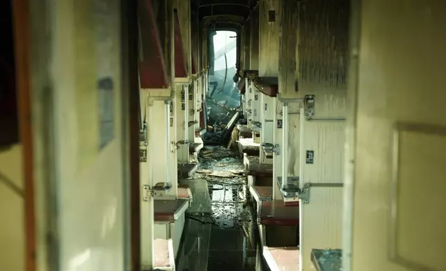 A passenger train is seen damaged following Russia's drone attack on a railway station in Shostka, Sumy region, Ukraine, Saturday, Oct. 4, 2025. (AP Photo/Kordon Media)