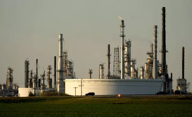 FILE - A motorist drives past the CHS oil refinery Sept. 28, 2024, in McPherson, Kan. (AP Photo/Charlie Riedel, File)