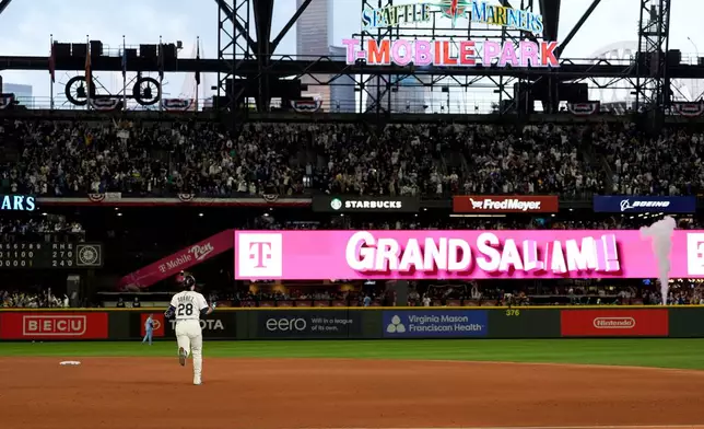Seattle Mariners' Eugenio Suárez rounds the bases after hitting a grand slam home run during the eighth inning in Game 5 of baseball's American League Championship Series against the Toronto Blue Jays, Friday, Oct. 17, 2025, in Seattle. (AP Photo/Lindsey Wasson)