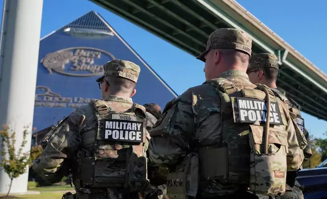 Members of National Guard patrol outside a Bass Pro Shops, Friday, Oct. 10, 2025, in Memphis, Tenn. (AP Photo/George Walker IV)