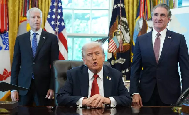 President Donald Trump speaks to reporters before signing an executive order in the Oval Office at the White House, Monday, Oct. 6, 2025, in Washington, as Energy Secretary Chris Wright and Interior Secretary Doug Burgum listen. (AP Photo/Jacquelyn Martin)