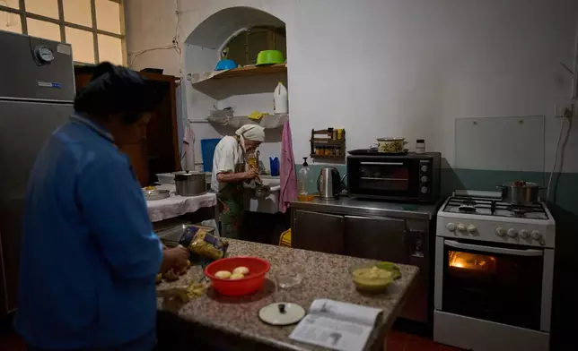 Lunch is prepared at the Benedictine monastery on top of the Mount of Olives during the olive harvest there, in Jerusalem, on Friday, Oct. 17, 2025. (AP Photo/Oded Balilty)