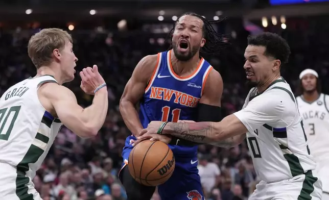 Milwaukee Bucks' Cole Anthony knocks the ball from New York Knicks' Jalen Brunson during the first half of an NBA basketball game Tuesday, Oct. 28, 2025, in Milwaukee. (AP Photo/Morry Gash)