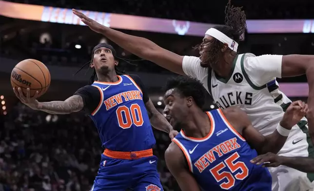 New York Knicks' Jordan Clarkson shoots past Milwaukee Bucks' Myles Turner during the first half of an NBA basketball game Tuesday, Oct. 28, 2025, in Milwaukee. (AP Photo/Morry Gash)