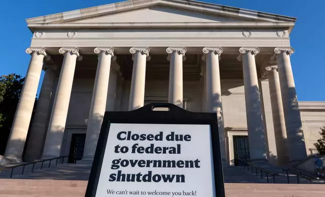 A sign that reads "Closed due to federal government shutdown," is seen outside of the National Gallery of Art on the 6th day of the government shutdown, in Washington, Monday, Oct. 6, 2025. (AP Photo/Jose Luis Magana)