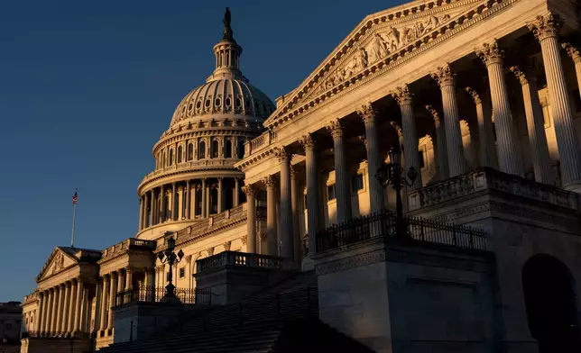 The Senate side of the Capitol is illuminated by the sun at dawn in Washington, Monday, Oct. 6, 2025. (AP Photo/J. Scott Applewhite)