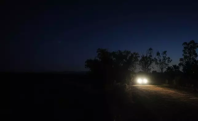 Researchers arrive at a sugarcane field at dawn to collect environmental data in Niland, Calif., Thursday, Sept. 11, 2025. (AP Photo/Jae C. Hong)