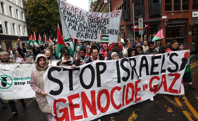 People take part in a demonstration organized by GM Friends of Palestine at Manchester Cathedral, in Manchester, England, Saturday, Oct. 4 2025. (Ryan Jenkinson/PA via AP)
