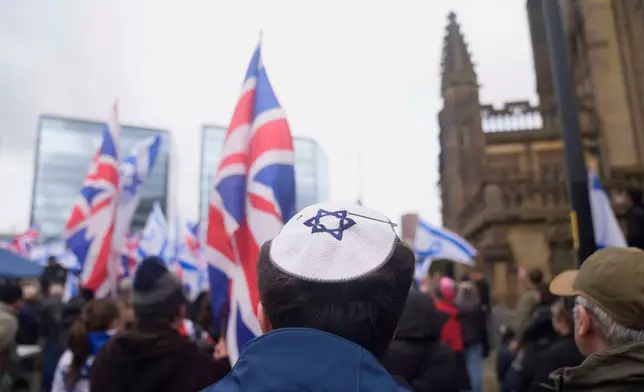 People attend a protest outside Manchester Cathedral following an attack at Heaton Park Hebrew Congregation synagogue in Crumpsall, where two people died, in Manchester, England, Sunday Oct. 5, 2025. (Danny Lawson/PA via AP)