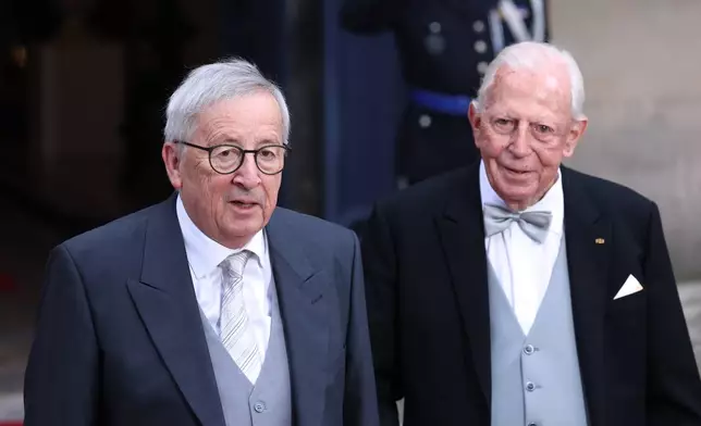 Luxembourg's Honorary Ministers of State Jean-Claude Juncker, left, and Jacques Santer arrive for the abdication and enthronement ceremony of the Grand Duke of Luxembourg at the Grand Ducal Palace in Luxembourg, Friday, Oct. 3, 2025. (AP Photo/Omar Havana)