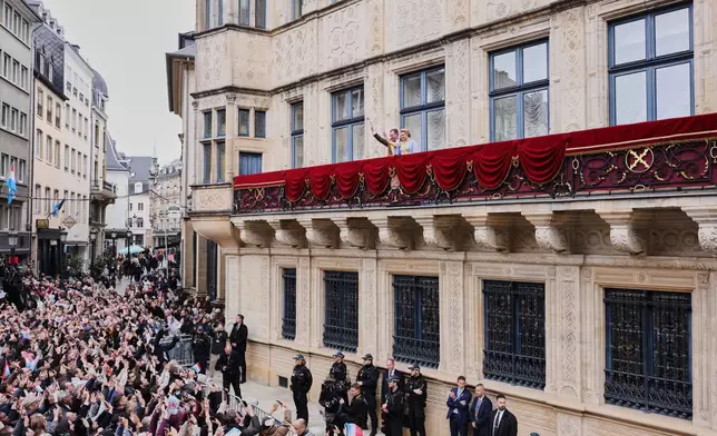 Luxembourg's Grand Duke Guillaume and Luxembourg's Grand Duchess Stephanie wave from the balcony of the Grand Ducal Palace in Luxembourg, Friday, Oct. 3, 2025. (AP Photo/Omar Havana)