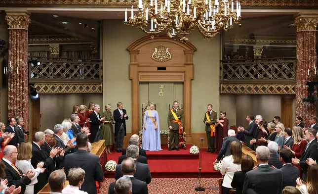 Luxembourg's Grand Duke Guillaume, center right, and Luxembourg's Grand Duchess Stephanie, center left, during a swearing-in ceremony in the session hall of the Chamber of Deputies in Luxembourg, Friday, Oct. 3, 2025. (AP Photo/Omar Havana)