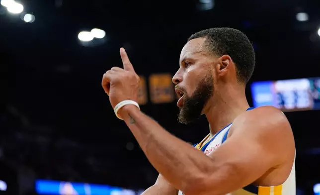 Golden State Warriors guard Stephen Curry reacts after scoring during the second half of an NBA basketball game against the Denver Nuggets, Thursday, Oct. 23, 2025, in San Francisco. (AP Photo/Godofredo A. Vásquez)