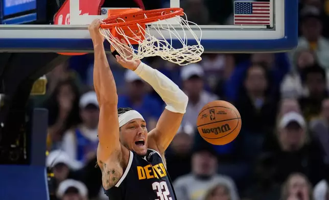 Denver Nuggets forward Aaron Gordon dunks during the second half of an NBA basketball game against the Golden State Warriors, Thursday, Oct. 23, 2025, in San Francisco. (AP Photo/Godofredo A. Vásquez)