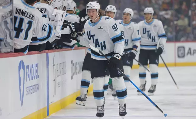 Utah Mammoth center Logan Cooley (92) is congratulated after scoring during the first period of an NHL hockey game against the Minnesota Wild, Saturday, Oct. 25, 2025, in St. Paul, Minn. (AP Photo/Bailey Hillesheim)