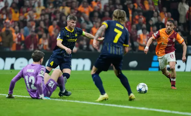 Galatasaray's Yunus Akgun, right, controls the ball during the Champions League opening phase soccer match between Galatasaray and Bodo Glimt, in Istanbul, Turkey, Wednesday, Oct. 22, 2025. (AP Photo/Khalil Hamra)
