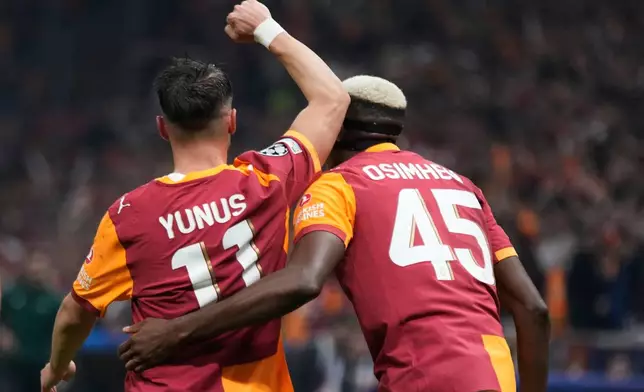 Galatasaray's Yunus Akgun, left, celebrates with Galatasaray's Victor Osimhen after scoring his side's third goal during the Champions League opening phase soccer match between Galatasaray and Bodo Glimt, in Istanbul, Turkey, Wednesday, Oct. 22, 2025. (AP Photo/Khalil Hamra)