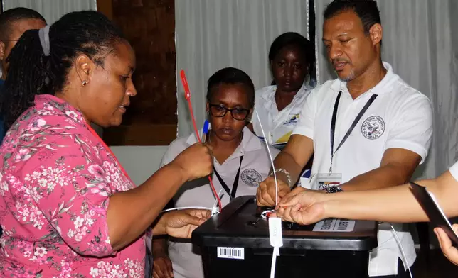 Election commission members count ballots after voting in a runoff presidential election at Mont Fleuri Secondary School polling station in Victoria, Seychelles, on Saturday, Oct. 11, 2025. (AP Photo/Emilie Chetty)