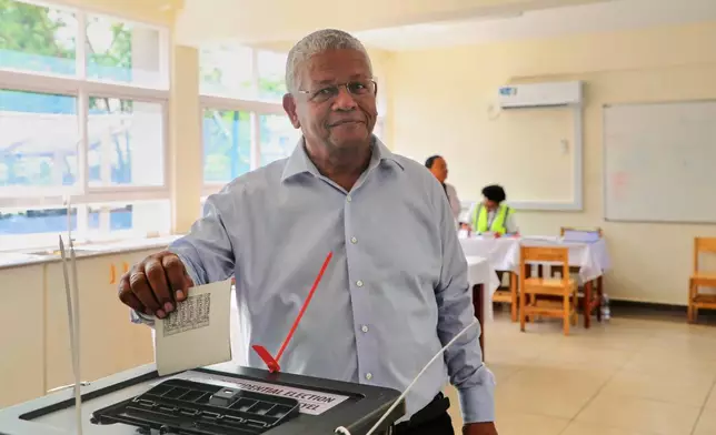 President Wavel Ramkalawan casts his vote in a runoff presidential election between him and opposition challenger Patrick Herminie, at Belonie Secondary School in St Louis, Mahe, Seychelles, Saturday, Oct. 11, 2025. (AP Photo/Emilie Chetty)