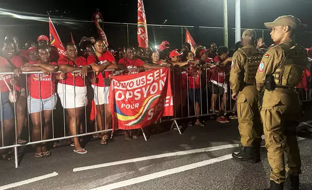 Supporters of President-elect Patrick Herminie celebrate after his winning in the runoff presidential election outside the Electoral Commision Headquarters in Victoria, Seychelles on Sunday, Oct. 12, 2025. (AP Photo/Emilie Chetty)