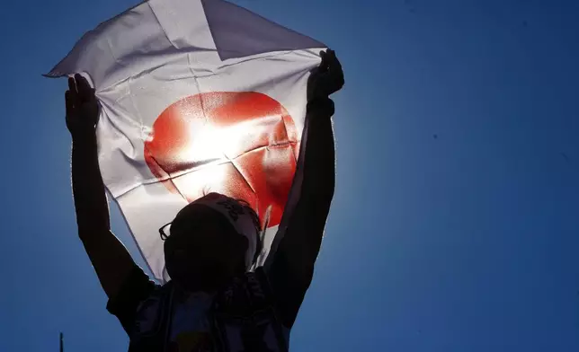 A fan of Japan attends a FIFA U-20 World Cup Group A soccer match between Japan and Egypt at National Stadium in Santiago, Chile, Saturday, Sept. 27, 2025. (AP Photo/Esteban Felix)